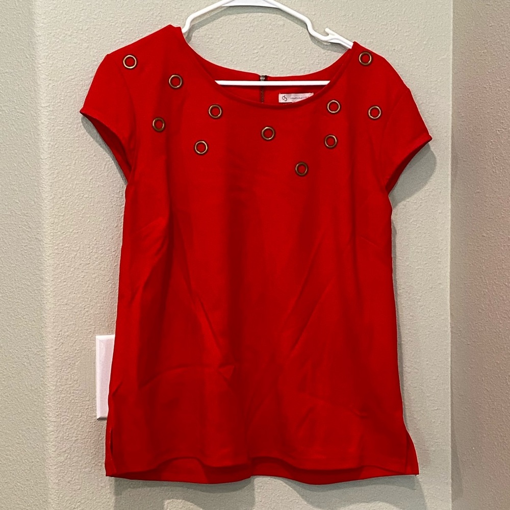 Vibrant red blouse with gold accents